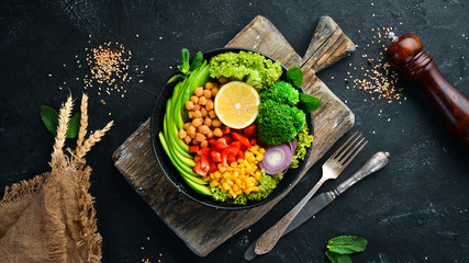 Healthy vegetarian food. Bowl Buddha. Avocados, broccoli, turkey peas, corn. Top view. Free space for your text.