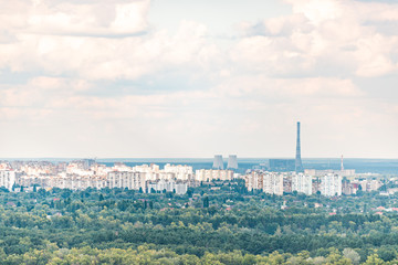 Kyiv, Ukraine overlook of city Kiev in summer with view of residential neighborhood Darnytsia suburbs Soviet buildings high angle aerial with industrial power plant
