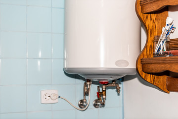 Rustic country home or house cottage tiled bathroom with closeup of water boiler and wooden shelf...