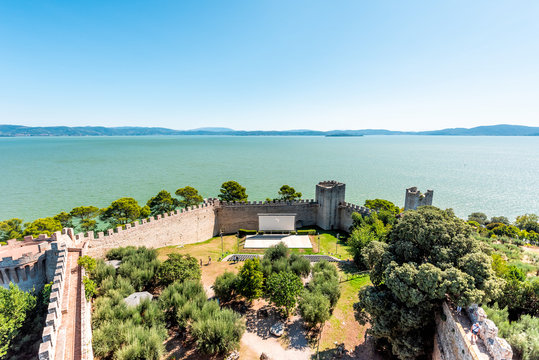 Castiglione del Lago medieval fortress fort in Umbria, Italy Rocca with Medievale o Rocca del Leone tower and lake Trasimeno high angle view in sunny summer day by amphitheater