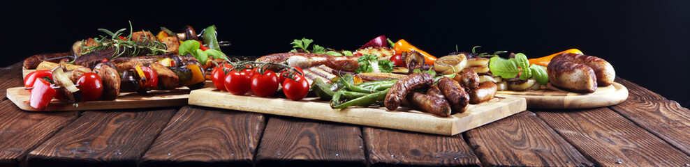 Assorted delicious grilled meat with vegetable on rustic table