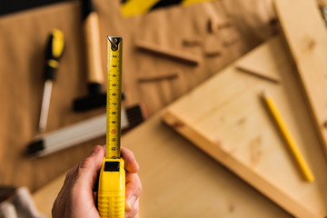 Carpenter with tape measure tool - obrazy, fototapety, plakaty