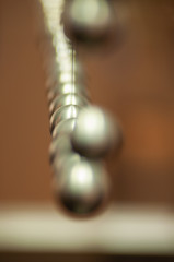 metal balls on string