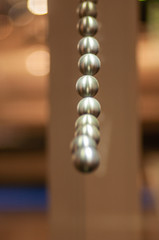 metal balls on string