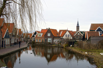 Naklejka na ściany i meble Traditional houses near canal in Holland town Volendam, Netherlands