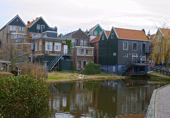 Traditional houses near canal in Holland town Volendam, Netherlands