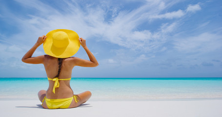 Luxury Travel. Beach woman enjoying serene luxury vacation relaxing under the sun looking at...