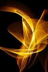 Yellow curled line - ribbon painted by light on the black background. Improvisational painting by light.