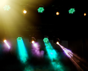 Stage lighting during a show on a dark background during a concert.