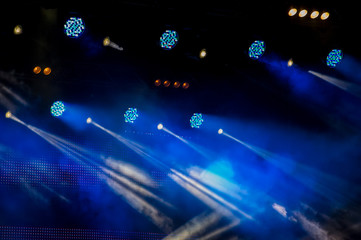 Stage lighting during a show on a dark background during a concert.