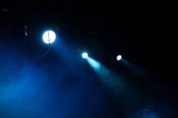 Theater stage lighting in a haze during the performance.