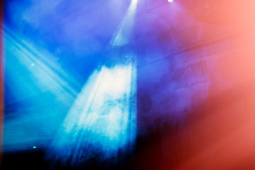 laser beams illuminate the scene in a haze during the performance.