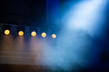 theatrical spotlights illuminate the stage during the performance. - obrazy, fototapety, plakaty