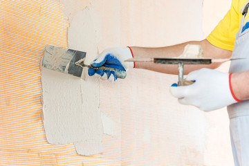 The worker's hand with a trowel.