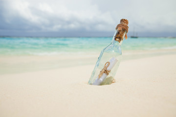 A letter in a bottle on the beach. Island lifestyle. White sand, crystal-blue sea of tropical beach. Ocean beach relax, travel to islands