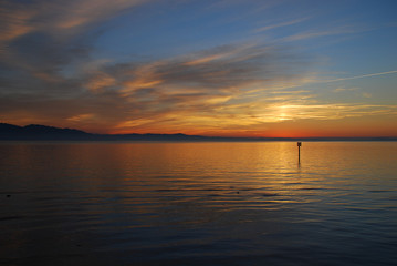 Fototapeta na wymiar Lindau, Germany: A view of the Bodensee (aka Lake Constance), in the distance Austria, and Switzerland, at sunset in the summer