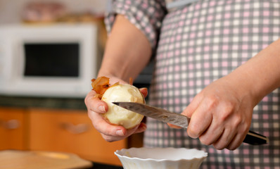 cook cleans onions in the kitchen