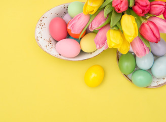 Fototapeta na wymiar Pink tulip flowers Easter eggs decoration yellow background