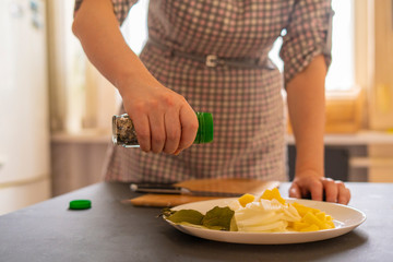 housekeeper prepares products for the soup and puts them on the plate