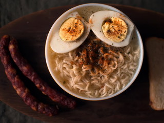 Twisted wavy noodles. Noodles in a black plate.