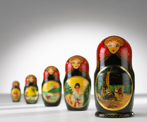 RUSSIAN DOLLS LINED UP ON WHITE BACKGROUND
