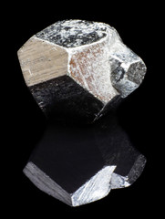 Natural piece of pyrite cube on a black background