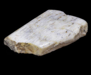 Natural piece of belomorite on black background