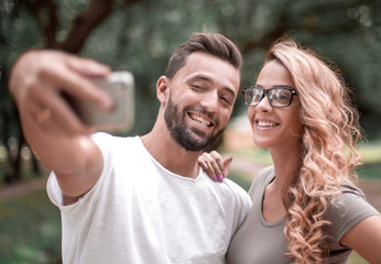 close up.smiling young couple taking selfie in city Park