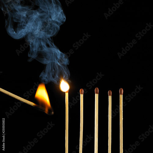 Burning Match Setting Fire To Row Of Five Matches Stock