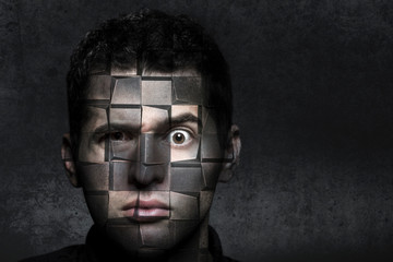 portrait of a man with a puzzled look that decomposes into cubes, concept of robotics