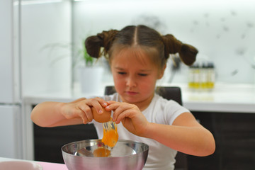 Little girl preparing cookies in kitchen at home. Cooking homemade food.