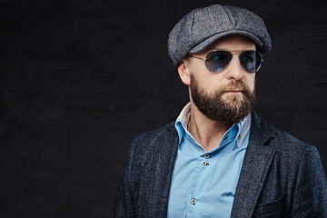 Close-up portrait of a successful stylish man in sunglasses wearing a beret and jacket