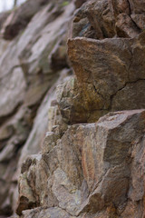 Fototapeta na wymiar Granite rocks with blurred background. Granite close up. Texture of the stone. Natural material background