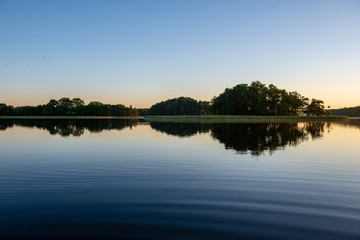 Fototapeta na wymiar calm weather sunset on country lake