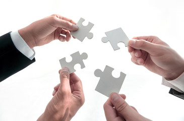 Hands and puzzle isolated on white background