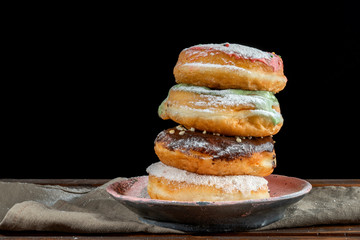 A stack of two donuts on black background.