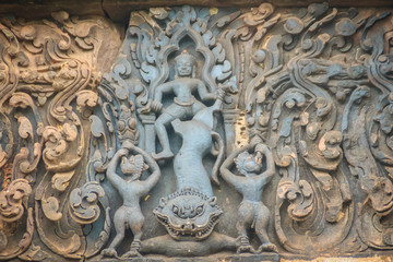 Fototapeta na wymiar Beautiful sandstone craved on the lintel, doorway and windows of Lord Krishna killing Lion in Bapuan Khmer art at Phra That Narai Cheng Weng, Sakon Nakhon, Thailand.