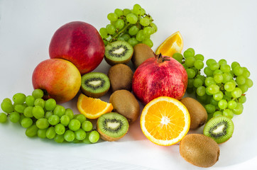 Tropical fruits on a white background, juicy still-life from fruit. Useful fruit for a healthy diet. Mix of different fruits.