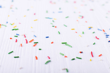 Powder like candy is scattered on the table. Happy Easter concept greeting card design.