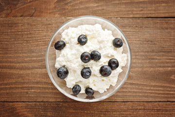 Top view close-up of curd and blueberries wooden background, healthy Breakfast