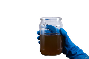 dirty contaminated infectious water in a jar in hand rubber glove isolated on white background