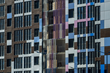 Facing the building with a ventilated facade. Aluminum colored facades. Modern facades of high-rise...