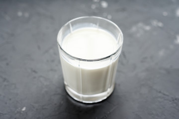 close-up of milk in glass cup on grey background