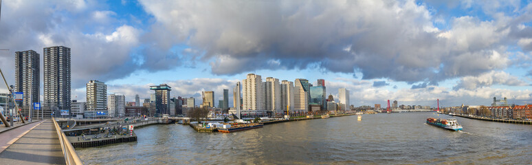 Fototapeta na wymiar Cityscape, panorama, banner - view from the Erasmus Bridge to the River Maas and the City of Rotterdam, The Netherlands, December 28, 2017