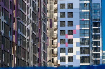 Facing the building with a ventilated facade. Aluminum colored facades. Modern facades of high-rise...