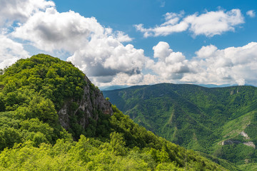 Spring in the mountain with puffy white clouds on sky