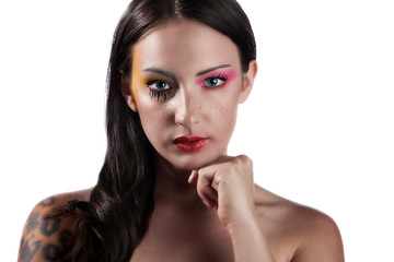 Young Caucasian Polish beauty model wears stunning cosmetics make-up that shows her stunning lips and bright colorful eye shadow in the studio 