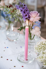 Pink cande on festive table