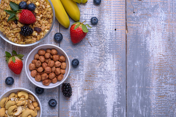 oat cereals with fruit, berries, nuts on wooden background