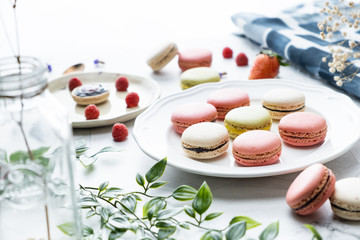 Macaron or French macaroon cookies dessert. Set on cafe table.